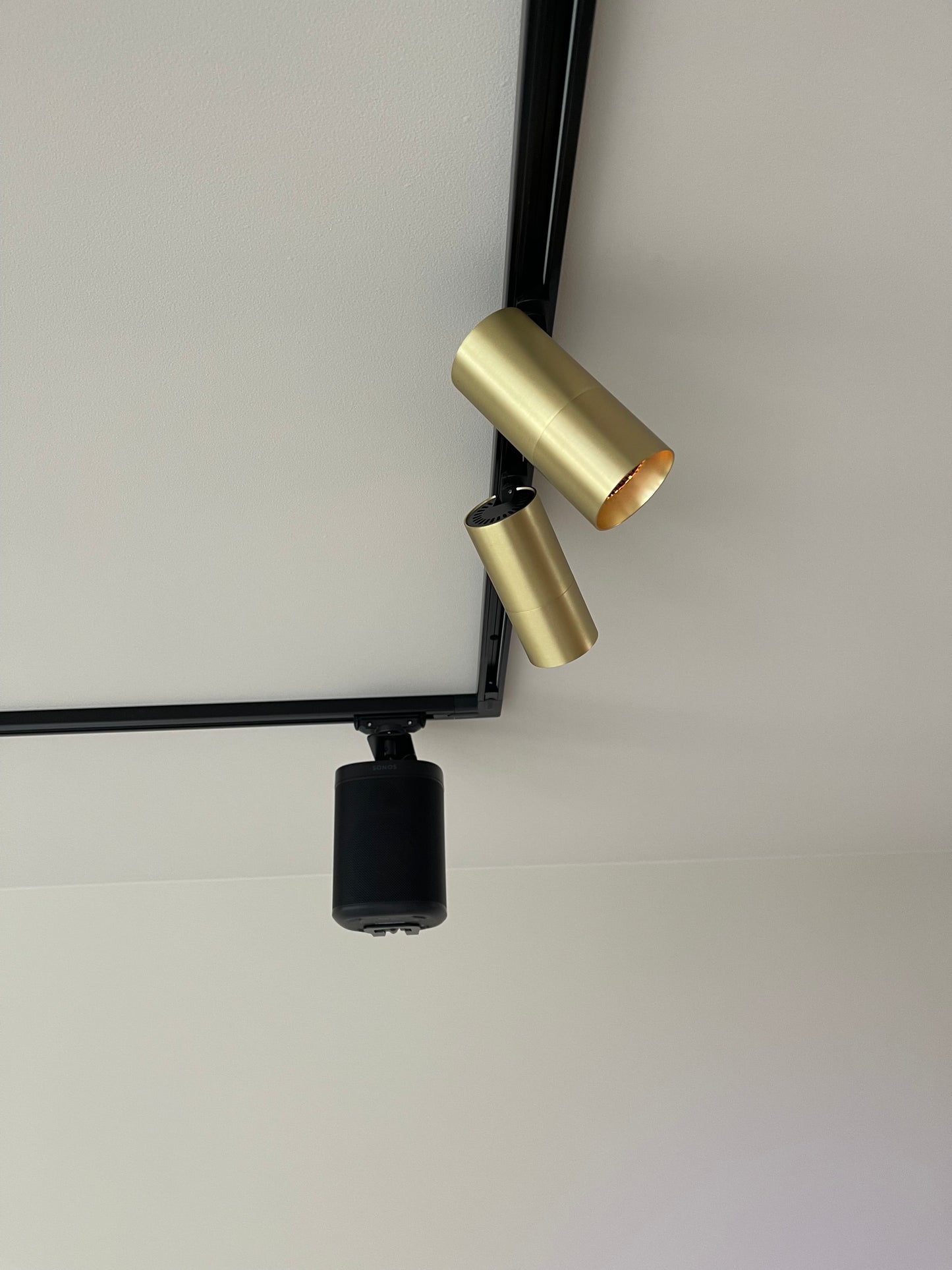 railverlichting met gouden railspots en sonos speakers