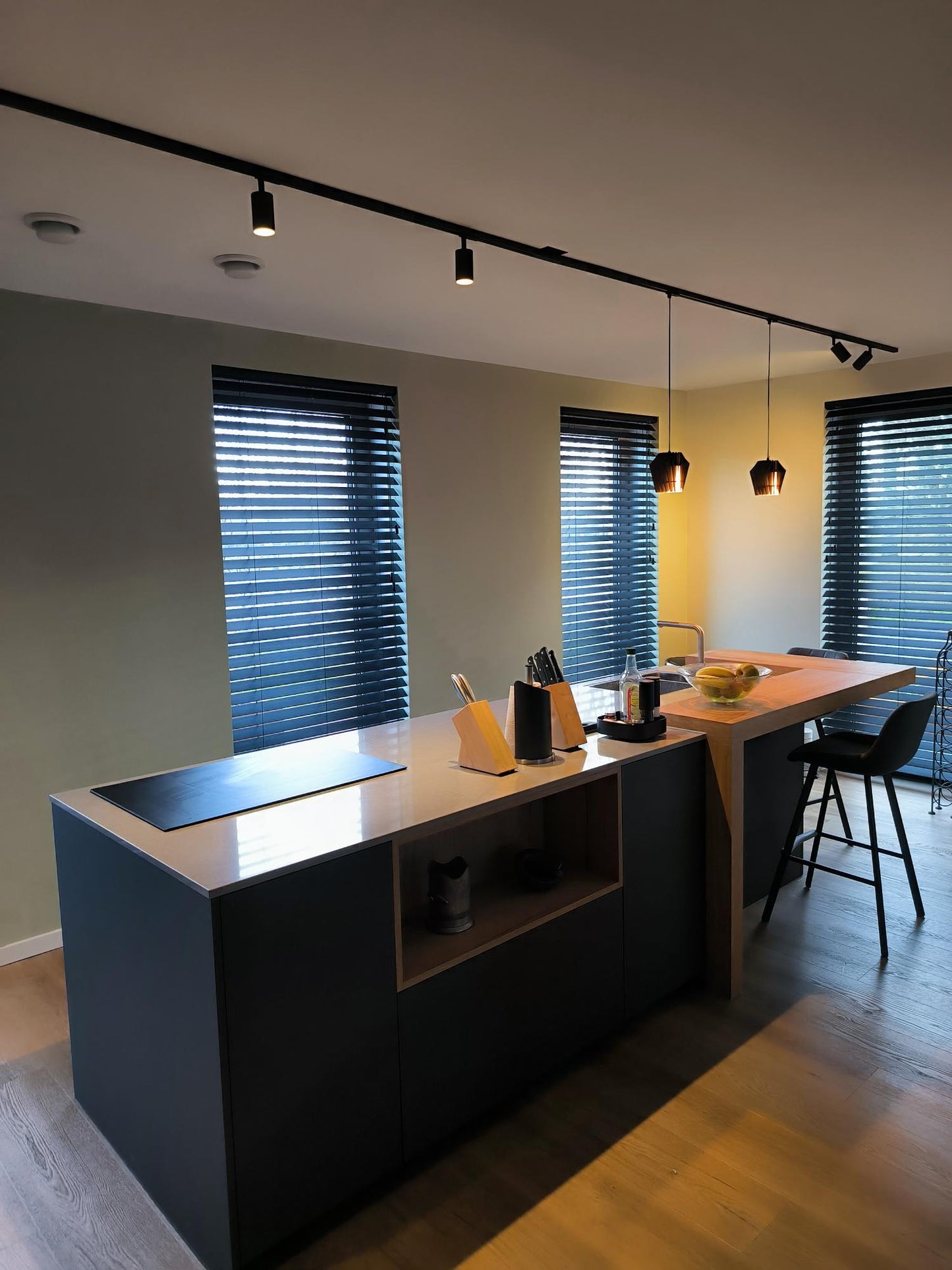 Houten hanglampen boven een eiland met Philips Hue erin